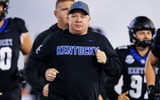 Oct 25, 2025; Lexington, Kentucky, USA; Kentucky Wildcats head coach Mark Stoops runs onto the field before the game against the Tennessee Volunteers at Kroger Field. Mandatory Credit: Jordan Prather-Imagn Images
