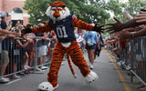 Sep 6, 2025; Auburn, Alabama, USA; Aubie, the Auburn Tigers mascot, greets fans as he goes through Tiger Walk before the game against the Ball State Cardinals at Jordan-Hare Stadium. Mandatory Credit: John Reed-Imagn Images