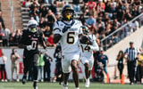 West Virginia defensive back Jordan Scruggs returns the pick-six against Houston