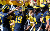 Michigan Wolverines football quarterback Bryce Underwood and the rest of the offense celebrate after a WR Donaven McCulley touchdown against Wisconsin. (Photo by Lon Horwedel / TheWolverine.com)