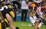 Iowa Hawkeyes offensive lineman Tyler Linderbaum (65) snaps the ball against the USC Trojans during the Holiday Bowl at SDCCU Stadium