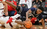 Nov 6, 2025; Louisville, Kentucky, USA; Jackson State Tigers guard Daeshun Ruffin (24) scrambles for the ball with Louisville Cardinals forward Khani Rooths (9) during the second half at KFC Yum! Center. Louisville defeated Jackson State 106-70. Mandatory Credit: Jamie Rhodes-Imagn Images