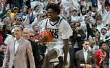 Michigan State Spartans forward Coen Carr (55) leaps down the court with the ball after the final buzzer and The Spartans beat Arkansas 69-66 at Jack Breslin Student Events Center. - Dale Young, USA TODAY Sports