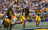 West Virginia's Curtis Jones scores the touchdown against Colorado