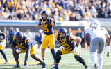 West Virginia Mountaineers quarterback Scotty Fox Jr. (15) changes the play at the line of scrimmage during the first quarter against the Colorado Buffaloes at Milan Puskar Stadium. Credit: Ben Queen-Imagn Images