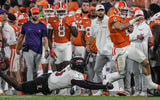 Nov 2, 2024; Clemson, South Carolina, USA; Clemson Tigers quarterback Cade Klubnik (2) runs against Louisville Cardinals linebacker Stanquan Clark (6) during the second quarter at Memorial Stadium. Mandatory Credit: Ken Ruinard-Imagn Images