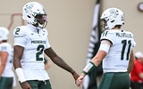 Michigan State Spartans quarterback Aidan Chiles (2) fist pumps Michigan State Spartans quarterback Alessio Milivojevic (11) prior to the game against the Indiana Hoosiers at Memorial Stadium. - Robert Goddin, USA TODAY Sports