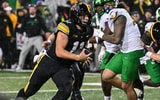 Iowa Hawkeyes quarterback Mark Gronowski (11) runs for a touchdown during the fourth quarter against the Oregon Ducks at Kinnick Stadium