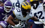 Nov 15, 2025; Chicago, Illinois, USA; Northwestern Wildcats defensive back Braden Turner (9) tackles Michigan Wolverines running back Jordan Marshall (23) during the first half at Wrigley Field. Mandatory Credit: David Banks-Imagn Images