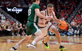 Nov 15, 2025; Louisville, Kentucky, USA; Louisville Cardinals guard Isaac McKneely (10) dribbles against Ohio Bobcats guard Jackson Paveletzke (13) during the first half at KFC Yum! Center. Mandatory Credit: Jamie Rhodes-Imagn Images