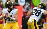 Iowa Hawkeyes quarterback Mark Gronowski (11) drops back to pass against the Southern California Trojans during the first half at the Los Angeles Memorial Coliseum. - Gary A. Vasquez, USA TODAY Sports