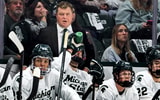 Michigan State's head coach Adam Nightingale, center, looks on from the bench during the first period in the game against New Hampshire on Thursday, Oct. 9, 2025, at Munn Ice Arena in East Lansing. - Nick King, USA TODAY Sports
