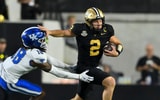Nov 22, 2025; Nashville, Tennessee, USA; Vanderbilt Commodores quarterback Diego Pavia (2) stiff arms Kentucky Wildcats defensive back Cam Dooley (18) during the second half at FirstBank Stadium. Mandatory Credit: Steve Roberts-Imagn Images