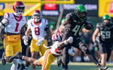 Oregon wide receiver Malik Benson carries the ball amid a tackle from USC safety Christian Pierce as the Oregon Ducks host the USC Trojans on Nov. 22, 2025, at Autzen Stadium in Eugene, Oregon