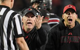 Louisville football coach Jeff Brohm pleads with the side judge as he and brother Greg Brohm -- UofL football's chief of staff -- look at the replay on the video board as officials ultimately ruled against a Chris Bell touchdown during the game against Clemson at L&N Stadium Friday, Nov. 14, 2025.