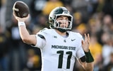 Nov 22, 2025; Iowa City, Iowa, USA; Michigan State Spartans quarterback Alessio Milivojevic (11) throws a pass against the Iowa Hawkeyes during the first quarter at Kinnick Stadium. (© Jeffrey Becker-Imagn Images)