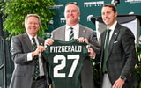 Michigan State football's new coach Pat Fitzgerald, center, holds up a jersey with MSU president KevinGuskiewicz, left, and athletic director J Batt, right, during Fitzgerald's introductory press conference. - Nick King, USA TODAY Sports