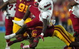 Fresno State Bulldogs running back Jordan Mims (7) is tackled by USC Trojans defensive back Anthony Beavers Jr. (15) in the first half at United Airlines Field at Los Angeles Memorial Coliseum