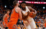 Dec 6, 2025; Nashville, Tennessee, USA;  Tennessee Volunteers forward Jaylen Carey (23) drives into Illinois Fighting Illini center Tomislav Ivisic (13) during the first half at Bridgestone Arena. Mandatory Credit: Steve Roberts-Imagn Images