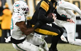 Dec 15, 2025; Pittsburgh, Pennsylvania, USA; Pittsburgh Steelers quarterback Aaron Rodgers (8) is sacked by Miami Dolphins linebacker Jordyn Brooks (20) in the first quarter at Acrisure Stadium.