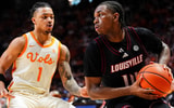 Louisville guard Adrian Wooley (14) is defended by Tennessee guard Amari Evans (1) during a college basketball game between Tennessee and Louisville held at Thompson-Boling Arena at Food City Center in Knoxville, Tenn., on Dec. 16, 2025.
