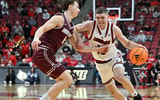 Dec 20, 2025; Louisville, Kentucky, USA; Louisville Cardinals guard Isaac McKneely (10) dribbles against Montana Grizzlies guard Tyler Isaak (8) during the second half at KFC Yum! Center. Louisville defeated Montana 94-54. Mandatory Credit: Jamie Rhodes-Imagn Images