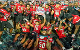 Dec 23, 2025; Boca Raton, FL, USA; Louisville Cardinals players celebrate after defeating the Toledo Rockets in the Boca Raton Bowl at Flagler CU Stadium. Mandatory Credit: Jeff Romance-Imagn Images