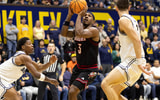 Dec 30, 2025; Berkeley, California, USA; Louisville Cardinals guard Ryan Conwell (3) shoots between California Golden Bears defenders Dai Dai Ames (7) and John Camden (2) during the first half at Haas Pavilion. Mandatory Credit: D. Ross Cameron-Imagn Images