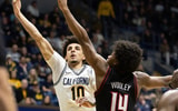 Dec 30, 2025; Berkeley, California, USA; California Golden Bears guard Justin Pippen (10) lays the ball up ahead of Louisville Cardinals guard Adrian Wooley (14) during the second half at Haas Pavilion. Mandatory Credit: D. Ross Cameron-Imagn Images