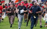 Dec 23, 2025; Boca Raton, FL, USA; Louisville Cardinals head coach Jeff Brohm leads his team on the field before the Boca Raton Bowl at Flagler CU Stadium. Mandatory Credit: Jeff Romance-Imagn Images