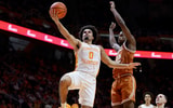 Jan 6, 2026; Knoxville, Tennessee, USA;  Tennessee Volunteers guard Ja'kobi Gillespie (0) goes to the basket against Texas Longhorns guard Tramon Mark (12) during the first half at Thompson-Boling Arena at Food City Center. Mandatory Credit: Randy Sartin-Imagn Images