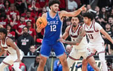 Duke Blue Devils forward Cameron Boozer (12) directs a play as Louisville Cardinals guard J'vonne Hadley (1) guards during a conference ACC game. January 6, 2026.