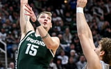 Michigan State's Carson Cooper, left, scores as Northwestern's Tyler Kropp defends during the first half on Thursday, Jan. 8, 2026, at the Breslin Center in East Lansing. - Nick King, USA TODAY Sports