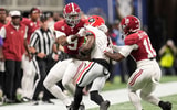 Dec 6, 2025; Atlanta, GA, USA; Georgia Bulldogs wide receiver Zachariah Branch (1) runs after making a catch and is tackled by Alabama Crimson Tide defensive back Cam Calhoun (9) and Alabama Crimson Tide linebacker Justin Jefferson (10) during the first quarter during the 2025 SEC Championship game at Mercedes-Benz Stadium. Mandatory Credit: Dale Zanine-Imagn Images