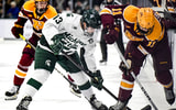 Michigan State's Tiernan Shoudy, left, and Minnesota's Tanner Ludtke battle for the puck during the third period on Friday, Jan. 23, 2026, at Munn Ice Arena in East Lansing. - Nick King, USA TODAY Sports