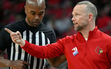 Jan 24, 2026; Louisville, Kentucky, USA; Louisville Cardinals head coach Pat Kelsey talks with official Jemel Spearman during the first half against the Virginia Tech Hokies at KFC Yum! Center. Mandatory Credit: Jamie Rhodes-Imagn Images