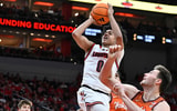 Jan 24, 2026; Louisville, Kentucky, USA; Louisville Cardinals guard Mikel Brown Jr. (0) shoots against Virginia Tech Hokies center Christian Gurdak (32) during the second half at KFC Yum! Center. Louisville defeated Virginia Tech 85-71. Mandatory Credit: Jamie Rhodes-Imagn Images