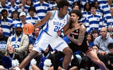 Jan 26, 2026; Durham, North Carolina, USA; Duke Blue Devils center Patrick Ngongba II (21) drives to the basket as Louisville Cardinals guard J'Vonne Hadley (1) defends during the first half at Cameron Indoor Stadium. Mandatory Credit: Rob Kinnan-Imagn Images