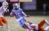 JTown's Larron Westmoreland looks for room to run as DeSale's Michael Ellis tries to make the stop in the fourth quarter Thursday night. The Colts defeated the unbeaten Chargers 21-18. Oct. 12, 2023. © Matt Stone/Louisville Courier Journal / USA TODAY NETWORK