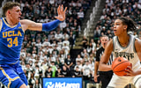 Michigan State's Jordan Scott, right, looks to pass as UCLA's Tyler Bilodeau closes in during the first half on Tuesday, Feb. 17, 2026, at the Breslin Center in East Lansing. - Nick King, USA TODAY Sports
