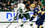 Michigan State's Gavin O'Connell, left, moves the puck against Notre Dame's Paul Fischer during the second period in the Big Ten tournament on Saturday, March 15, 2025, at Munn Arena in East Lansing. - Nick King, USA TODAY Sports