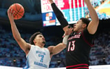 Feb 23, 2026; Chapel Hill, North Carolina, USA; North Carolina Tar Heels guard Seth Trimble (7) shoots as Louisville Cardinals forward Sananda Fru (13) defends in the second half at Dean E. Smith Center. Mandatory Credit: Bob Donnan-Imagn Images