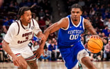 Feb 24, 2026; Columbia, South Carolina, USA; Kentucky Wildcats guard Otega Oweh (00) drives around South Carolina Gamecocks guard Meechie Johnson (5) during the second half at Colonial Life Arena. Mandatory Credit: Jeff Blake-Imagn
