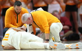 Feb 28, 2026; Knoxville, Tennessee, USA;  Tennessee Volunteers forward Nate Ament (10) is attended to after an injury during the first half against the Alabama Crimson Tide at Thompson-Boling Arena at Food City Center. Mandatory Credit: Randy Sartin-Imagn Images
