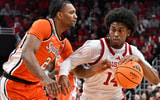 Mar 3, 2026; Louisville, Kentucky, USA; Louisville Cardinals guard Adrian Wooley (14) dribbles against Syracuse Orange guard JJ Starling (2) during the first half at KFC Yum! Center. Mandatory Credit: Jamie Rhodes-Imagn Images