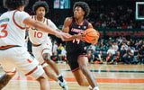 Mar 7, 2026; Coral Gables, Florida, USA; Louisville Cardinals guard Adrian Wooley (14) drives to the basket against Miami Hurricanes guard Tre Donaldson (3) at Watsco Center. Mandatory Credit: Jeff Romance-Imagn Images