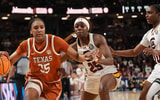 ;Texas Longhorns forward Madison Booker (35) brings the ball up court defended by South Carolina Gamecocks guard Raven Johnson (25) during the first half at Bon Secours Wellness Arena. Mandatory Credit: Jim Dedmon-Imagn Images