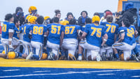 The Barrow Whalers huddles before an Alaska high school football game.