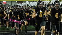 The Southeast Polk Rams take the field before an Iowa high school football game against the Waukee Warriors.