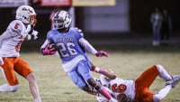 JTown's Larron Westmoreland looks for room to run as DeSale's Michael Ellis tries to make the stop in the fourth quarter Thursday night. The Colts defeated the unbeaten Chargers 21-18. Oct. 12, 2023. © Matt Stone/Louisville Courier Journal / USA TODAY NETWORK